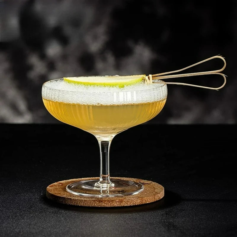 Coupe à cocktail cannelée transparente avec zeste de citron vert