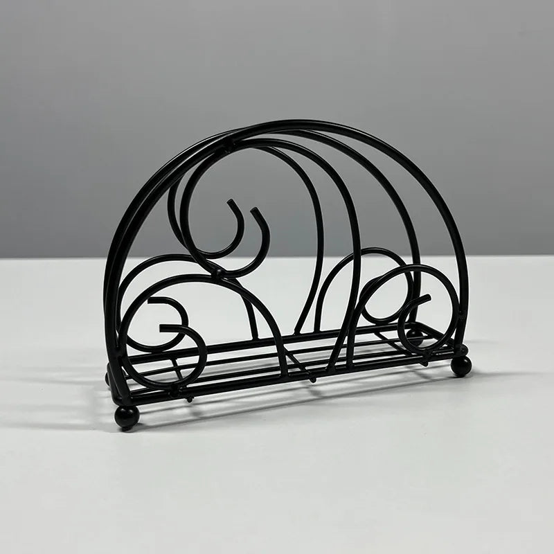 Porte-serviettes noir en demi-cercle à volutes, variante Noir Arche 3, posé sur une table blanche